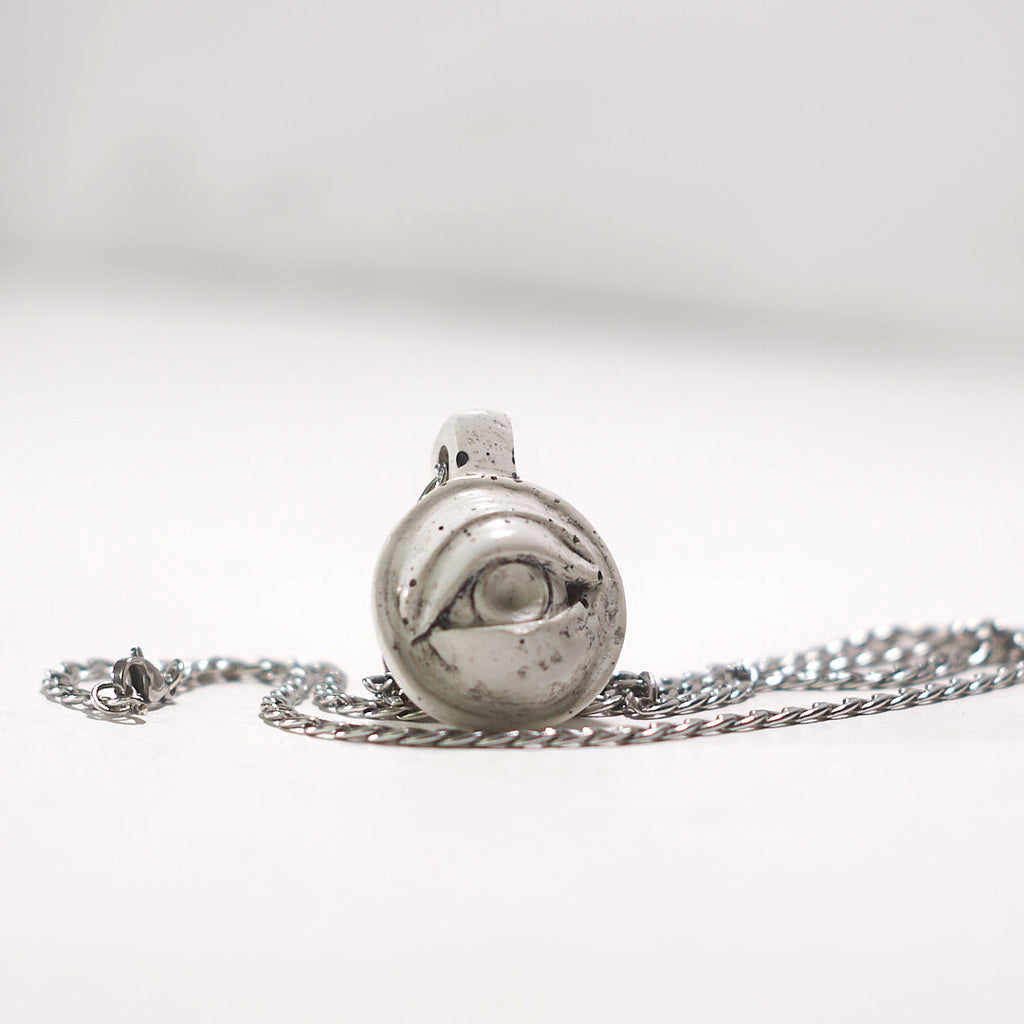 small evil white eye pendant
