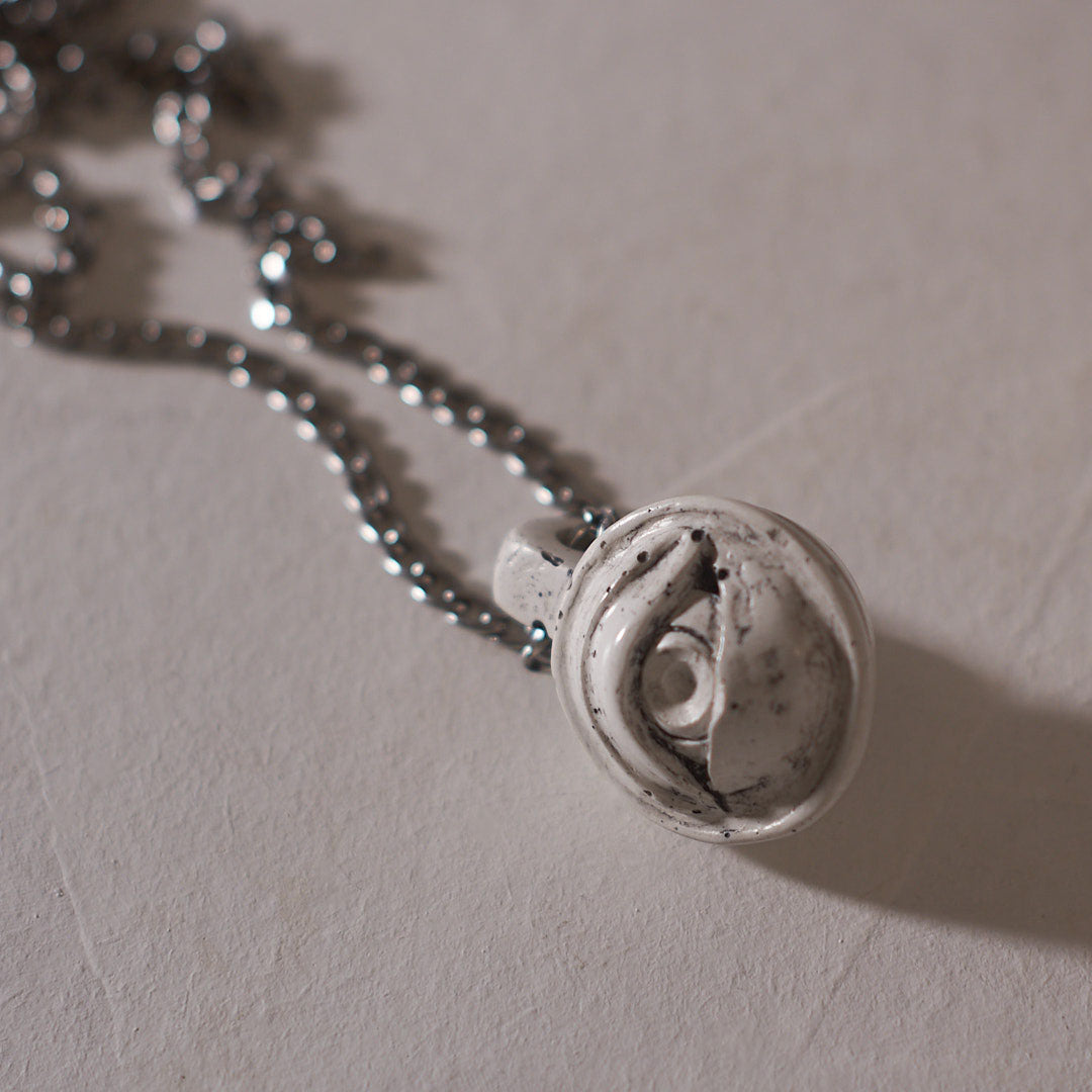 small white eye pendant silver steel chain