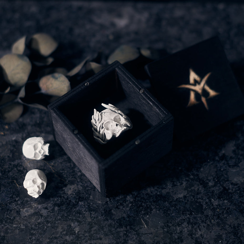 crown of leaves skull ring and white skull collar pins