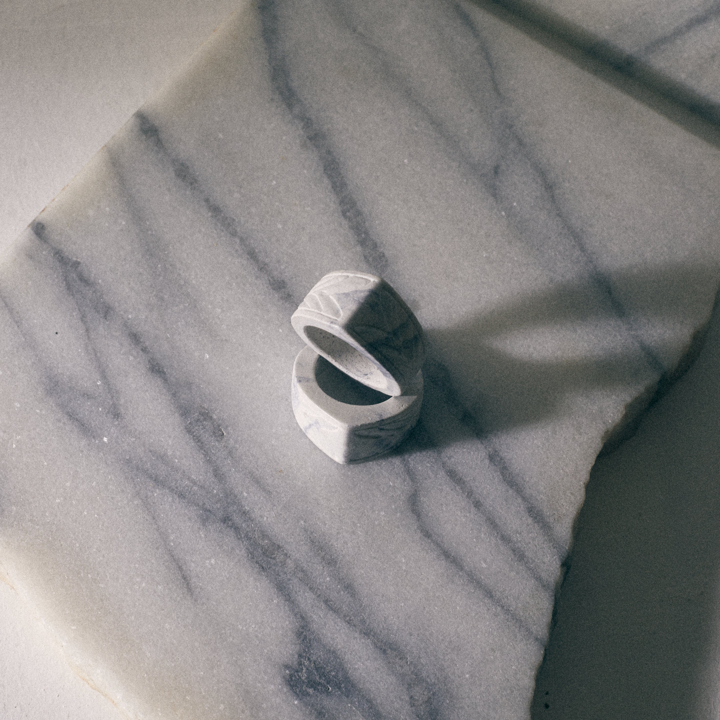 white alchemy ring over carrara marble
